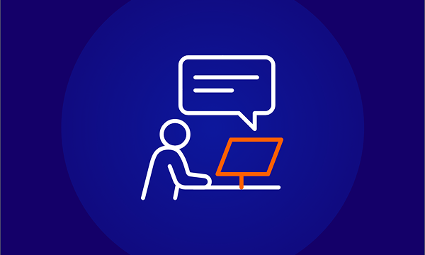 An icon of a person with a white outline sitting at a white desk with a computer monitor, which has an orange outline. A white speech bubble is above the person's head. This represents a computer-based exam (CBE) or an online test.