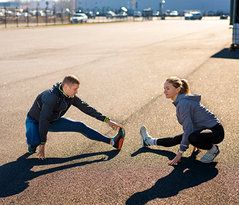 Tekača zaključujeta uspešen trening z razteznimi vajami
