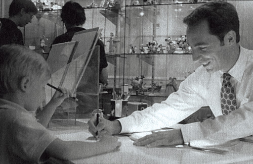 Jim Fern shows a boy how to draw Mickey Mouse in the Art of Disney Gallery at Walt Disney World&rsquo;s Epcot theme park in 1999.