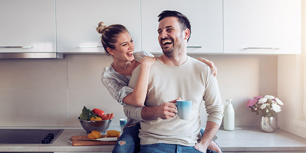 couple laughing in the kitchen