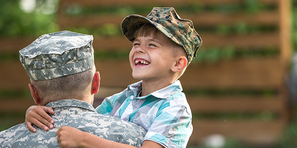 son happiliy hugging his military father