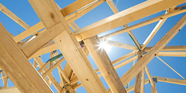 the sun shines through the spaces in a wooden house frame