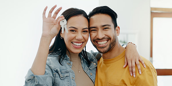 couple showing of new house keys