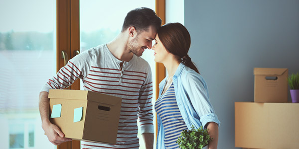 couple sharing a moment while moving into their new home