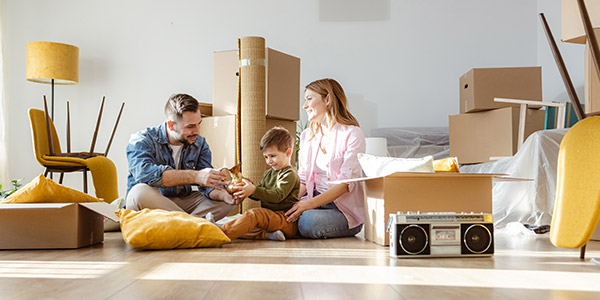 family sitting on the floor of their new house