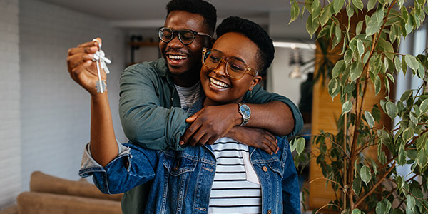 happy couple showing off their new house keys