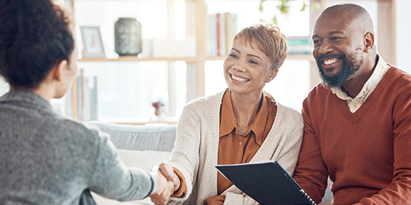 agent shaking hands with clients