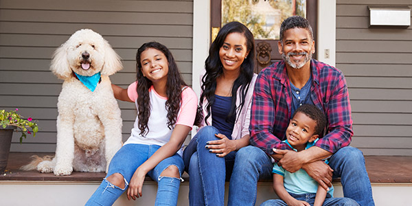 happy family sitting on their front stairs