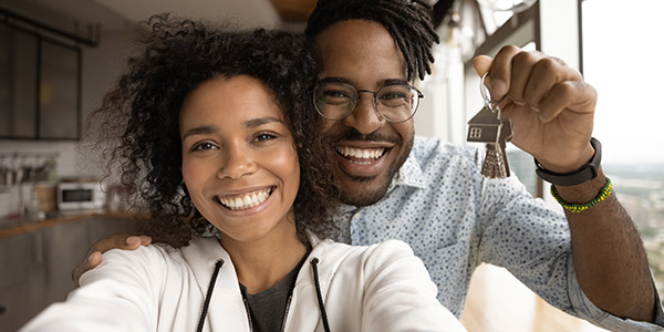 happy Black couple holding house keys