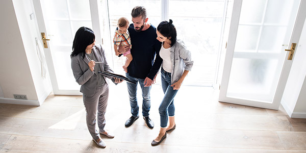 real estate agent viewing a house with homebuyers