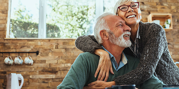 lovely senior couple hugging in the kitchen