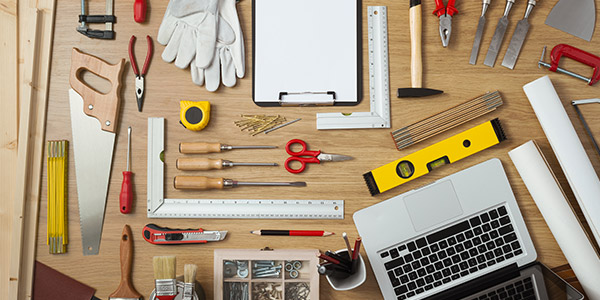 Various home improvement tools laid out on a desk top