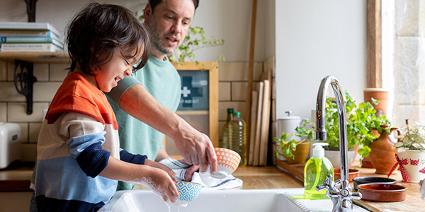 father and son washing dishes