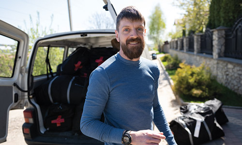 Joe Ampe loads duffel bags of supplies into a van in Ternopil, Ukraine, during his second delivery trip in May.