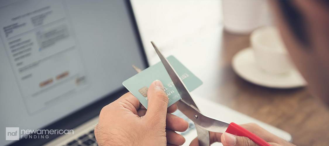 cutting a credit card with scissors