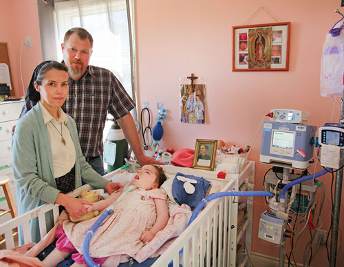 Marc and Carole Jobin stand with Marie-Ange, now 4 years old, in her new room.