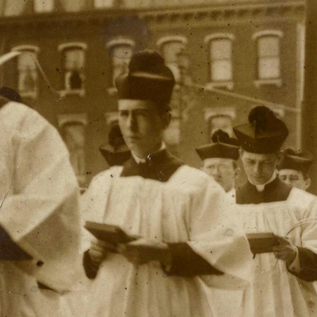 Video clip from Anerican Blessed of priests walking in a procession holding bibles and praying.