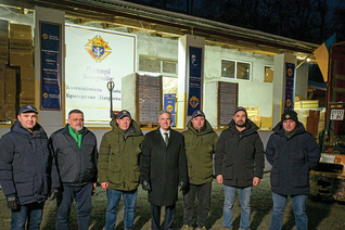 Knights in Lviv, Ukraine, gather with the supreme knight Dec. 6 outside of the warehouse that regularly receives pallets of care packages and other goods delivered by K of C Charity Convoys from Poland. Photo by Tamino Petelinšek