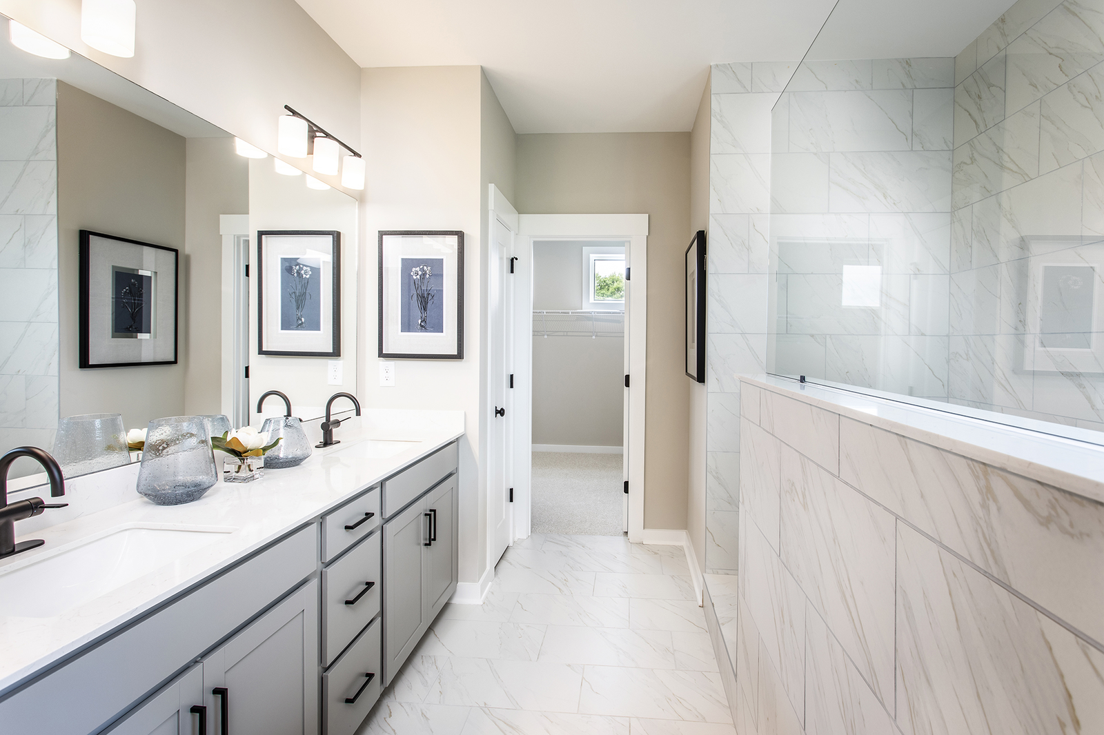 primary bath with gray cabinets and oversized walk-in shower