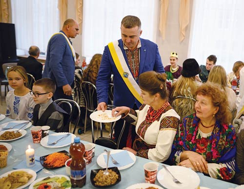 Members of Sts. Borys and Hlib Council 17740 in Fastiv serve guests during a Christmas dinner for bereaved families Jan. 5. (Photo by Andrey Gorb)