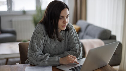Woman sitting at a desk working on a laptop