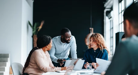 A group of colleagues working together in a contemporary office environment.