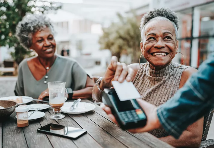 Senior woman making credit card payment 